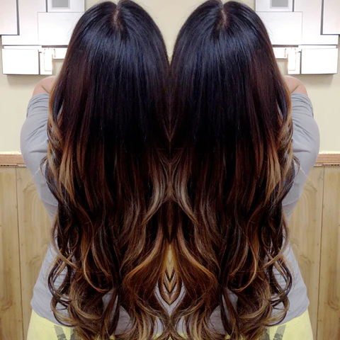 Brunette admiring her long hair extensions in the mirror