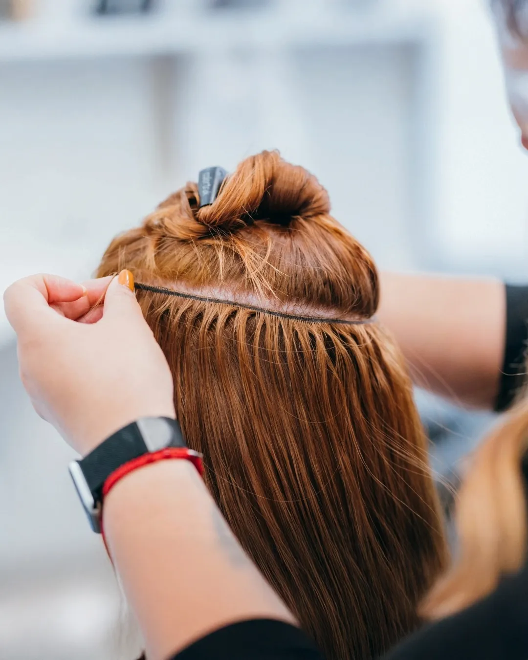Placing red hair extensions