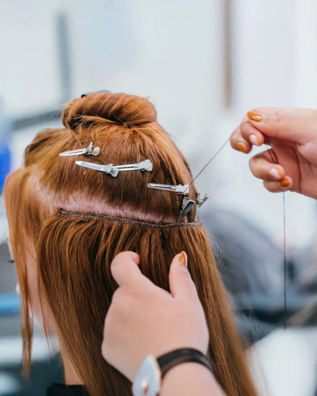 Sewing red hair extensions weft