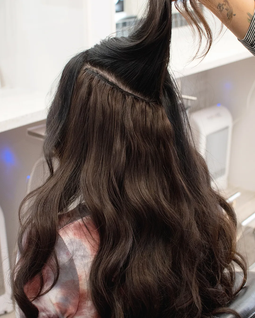 Invisible Weft Hair Extensions - Stylist Pulls Hair Up to Show Placement of Weft